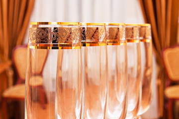 Row of empty wine goblets in restaurant. Shallow DOF effect