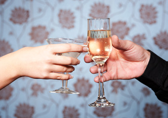 Hands with glasses of vine and Martini