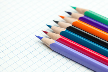 plaid notebook with a spiral  and colored  pencil