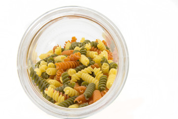 Colorful raw fusilli in a jar