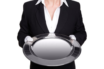 Female butler holding a silver tray isolated on white.