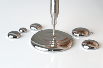 Mercury pouring from a pipette - obrazy, fototapety, plakaty