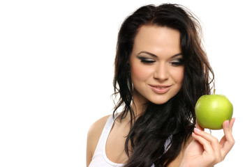 Portrait of a young brunette holding a fresh green apple