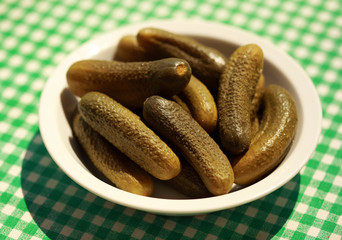 Pile of pickled cucumbers on the white plate