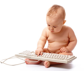 Little child is typing on keyboard