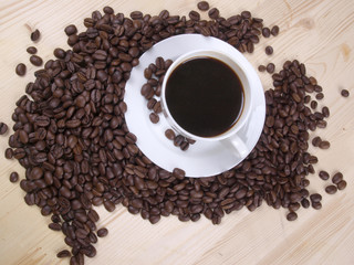Coffee beans and a white cup