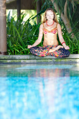 young beautiful woman doing yoga on natural background