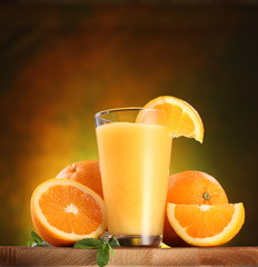Oranges and glass of juice.