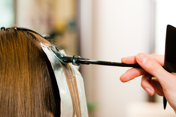 At the hairdresser – woman gets new hair colour