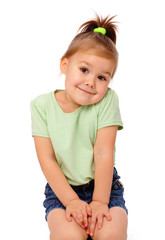 Cute little girl is sitting on floor and smile