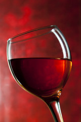 Red vine in glass on vintage background