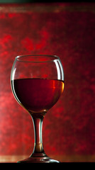 Red vine in glass on vintage background