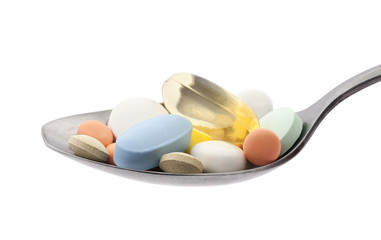 Pills on spoon with clipping path