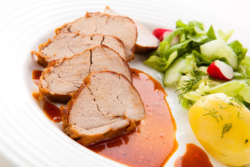 Roasted pork loin slices with vegetables