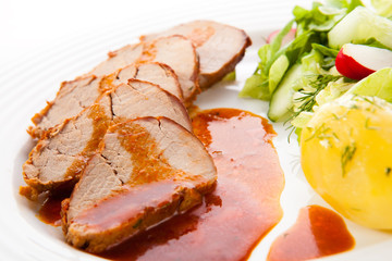 Roasted pork loin slices with vegetables