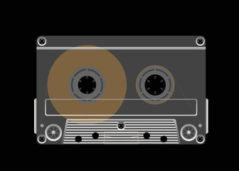 Compact cassette on a black background.