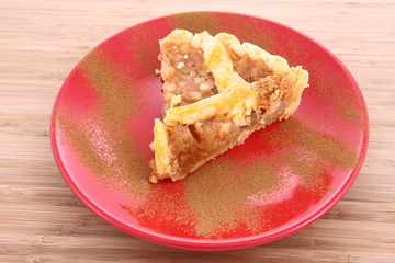Apple Pie - a slice on a plate decorated with cinnamon