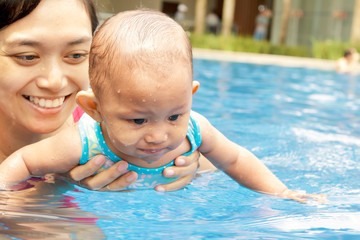 Fototapeta na wymiar Mother teach baby to swim