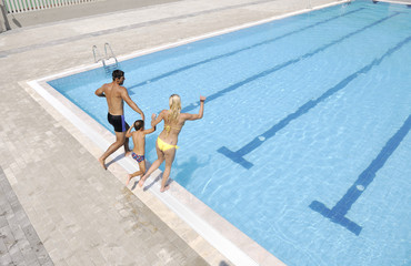 happy young family have fun on swimming pool