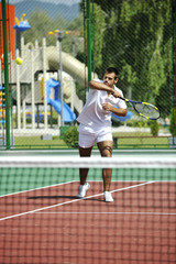 Fototapeta na wymiar young man play tennis outdoor