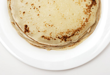 yellow pancakes on a white plate closeup