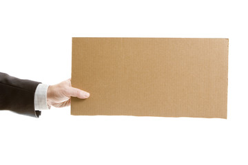 Businessman`s hand holding a blank cardboard sign