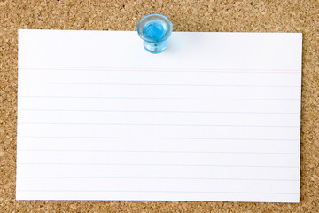 Blank index card pinned to a corkboard