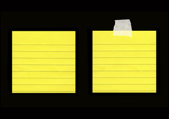 Yellow lined post-its isolated on black