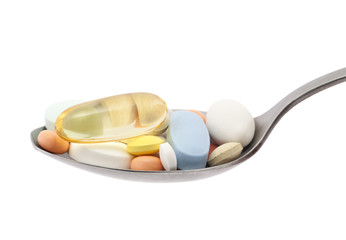 Pills on spoon with clipping path