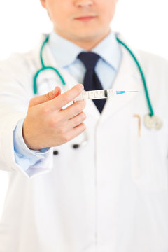 Doctor with medical syringe in hands. Close-up.