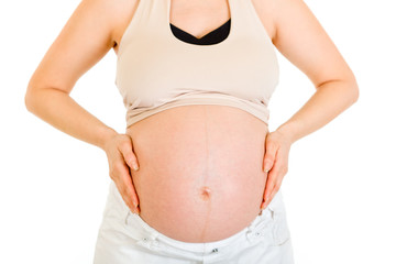 Pregnant woman holding her belly isolated on white. Close-up..