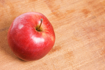 Red apple on a wooden table