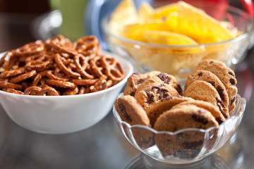 Cookies and pretzels in bowls, shallow DOF