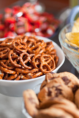 Cookies and pretzels in bowls, shallow DOF