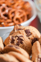 Cookies and pretzels in bowls, shallow DOF