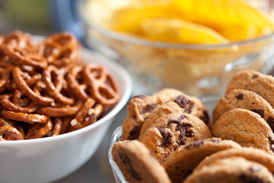 Cookies and pretzels in bowls, shallow DOF