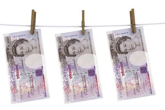 pounds sterling on the line with clothes pins