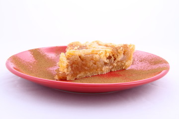 Apple Pie - a slice on a plate decorated with cinnamon