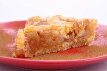 Apple Pie - a slice on a plate decorated with cinnamon