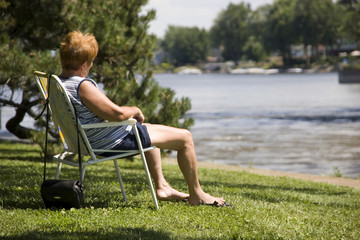 Fototapeta premium Woman relaxing by a lake
