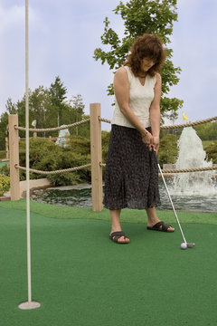 Woman enjoying a round of mini golf