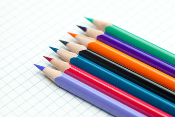 plaid notebook with a spiral  and colored  pencil