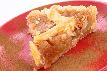 Apple Pie - a slice on a plate decorated with cinnamon