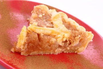 Apple Pie - a slice on a plate decorated with cinnamon