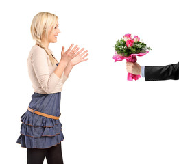 Surprised blond girl accepting bunch of flowers