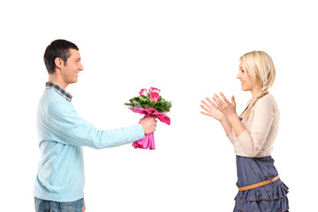 Boyfriend giving flowers to his surprised girlfriend