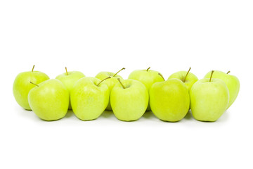Green and yellow apples on a white baclground