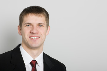 Handsome smiling young businessman.