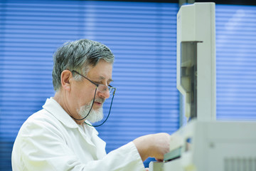 senior male researcher carrying out scientific research in a lab