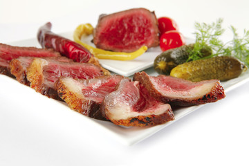 meat sliced with tomatoes and peppers